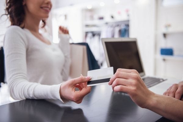 A woman paying for mental health care through her private health insurance