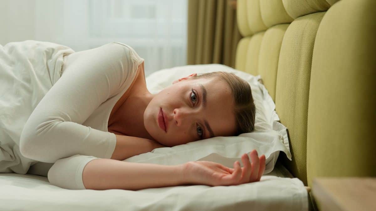 A person lying in bed experiencing symptoms of avoidant personality disorder. Treatment is available in Melbourne at Fullarton Clinic