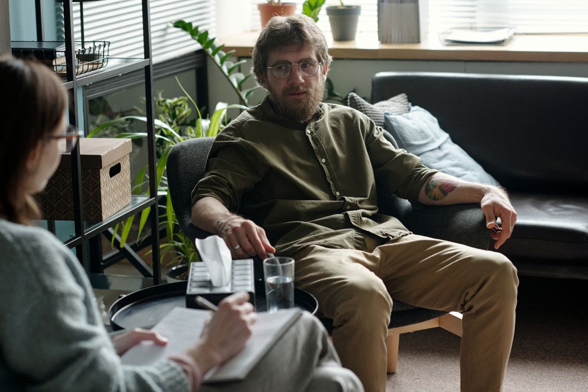 An image of a man in group therapy for PTSD treatment is available in Melbourne at Fullarton Clinic.